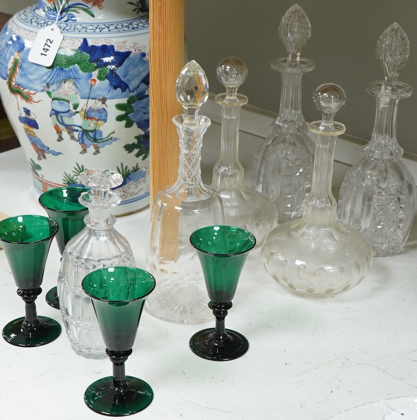 A set of four 19th century Bristol green glasses, an early 19th century spirit decanter and other Victorian decanters
